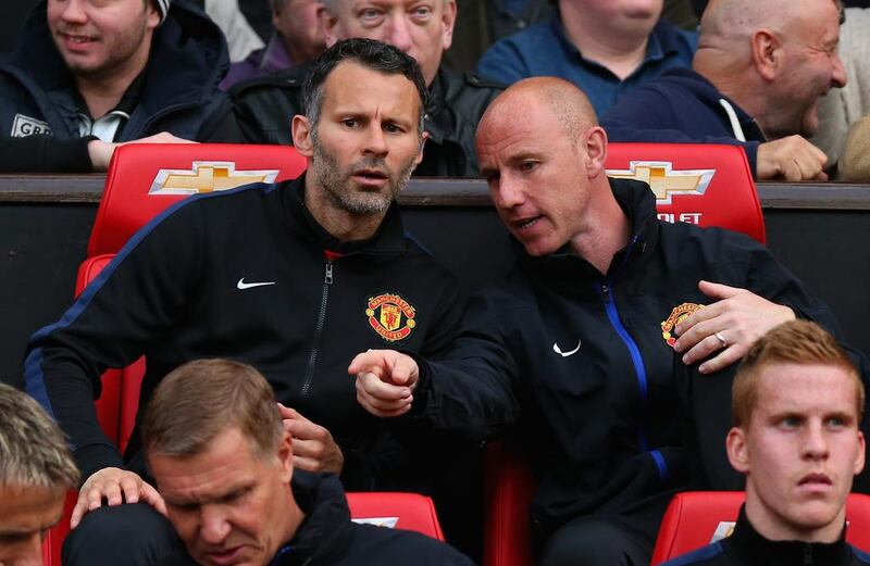 Manchester United interim manager Ryan Giggs speaks with Nicky Butt prior to Tuesday's Premier League match against Hull City. Alex Livesey / Getty Images / May 6, 2014