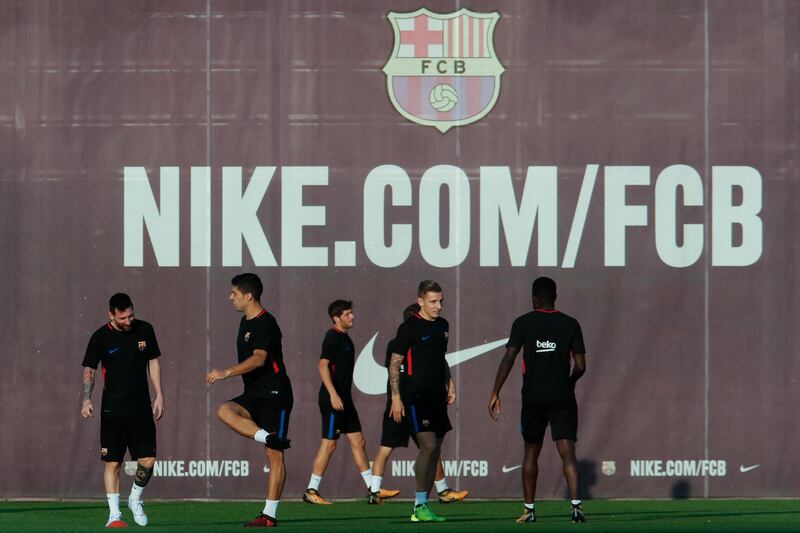 Barcelona player including Lionel Messi, left, take part in a training session. Pau Barrena / AFP