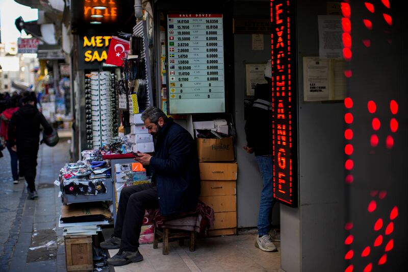 Exchange rates displayed in an Istanbul market. The country's central bank increased interest rates to 50 per cent on Thursday in a surprise move. AP