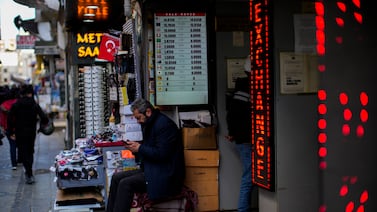 Exchange rates displayed in an Istanbul market. The country's central bank increased interest rates to 50 per cent on Thursday in a surprise move. AP