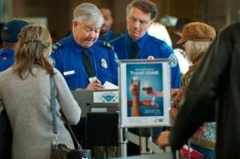 TSA Officers review air traveler's boarding passes and identification at a security checkpoint inside Ronald Reagan Washington National Airport December 27, 2009, in Arlington, VA, near Washington, DC.  AFP Photo/Paul J. Richards *** Local Caption ***  521424-01-08.jpg
