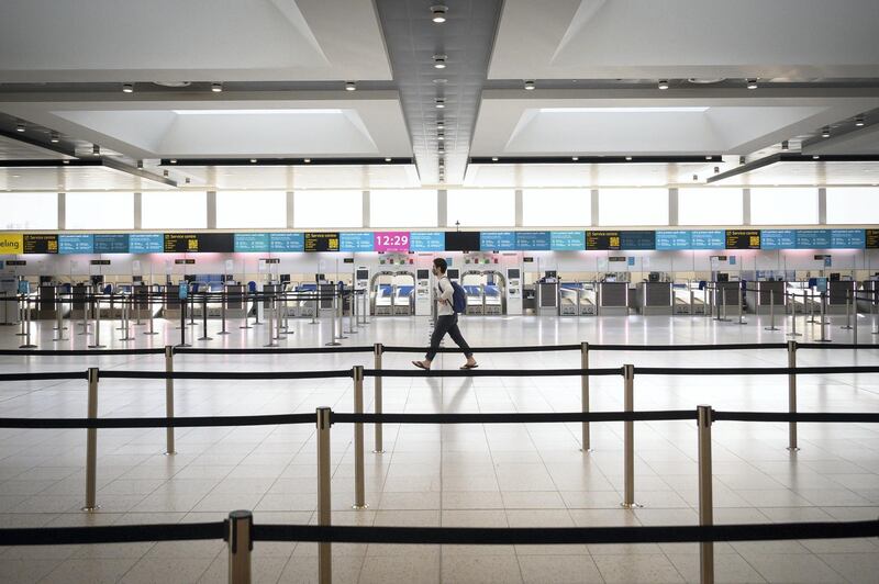 LONDON, ENGLAND - NOVEMBER 27: A passenger walks past the deserted check-in desks and passenger facilities in the North Terminal at Gatwick Airport on November 27, 2020 in London, England. Gatwick airport is launching a facility to purchase PCR swab tests, allowing passengers to travel to destinations which require them to prove they are Covid-free. Due to the COVID-19 pandemic, the number of travellers has fallen dramatically. During the period between July and September, the airport registered an 86% drop in passengers compared to the same period in 2019. The service, provided by ExpressTest, charges Â£60 per passenger flying from Gatwick, or Â£99 for general members of the public. (Photo by Leon Neal/Getty Images)