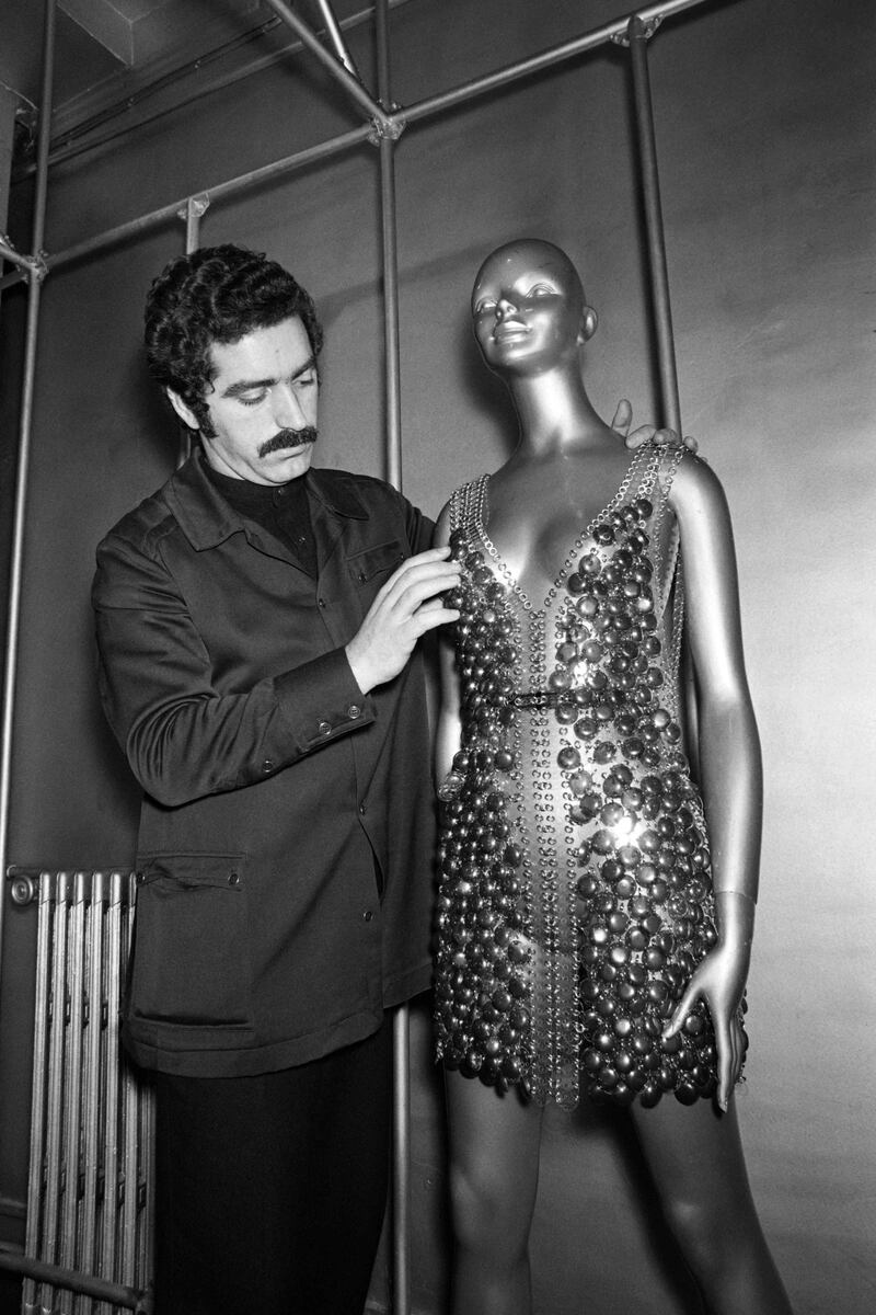 Working on a dress for his spring/summer collection in Paris in 1970. AFP