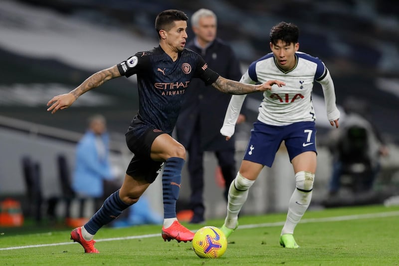 City's Joao Cancelo under pressure from Son Heung-min of Spurs. AP