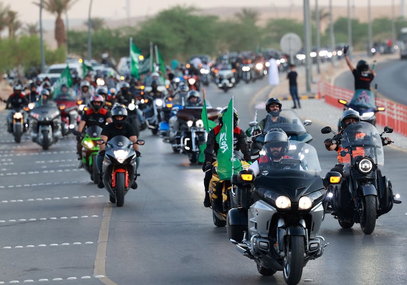 Bikers wave flags as they ride their motorcycles around the capital Riyadh during a parade to mark Saudi National Day.  All photos: AFP