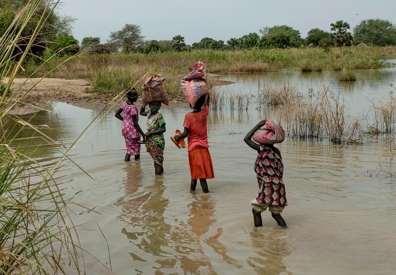 Children walk through flooded fields near Malualkon. Having already had to contend with a five-year civil war, hunger and corruption, South Sudan – the world's youngest country – now faces the challenge of extreme weather.