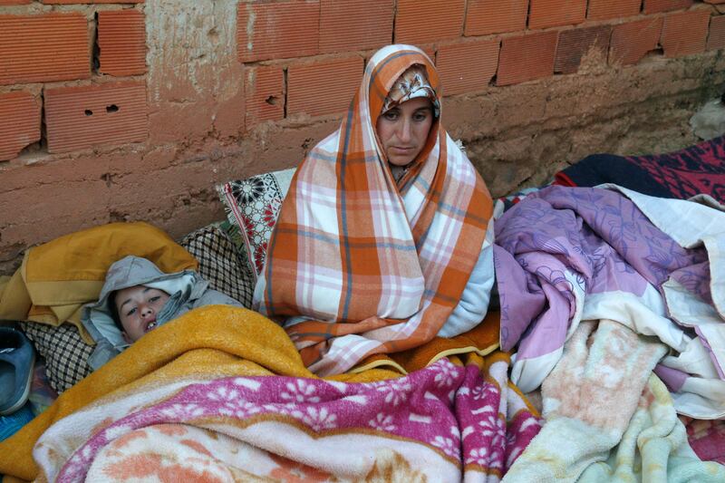 A woman waits for news at the site. AFP