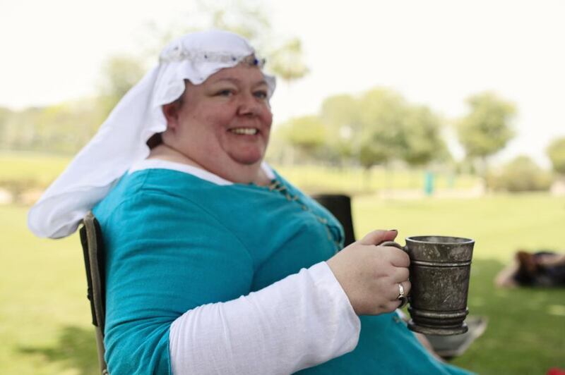 Joanne Labny aka Lady Fiona cools off with a drink of water in her pewter mug in Safa Park in Dubai.