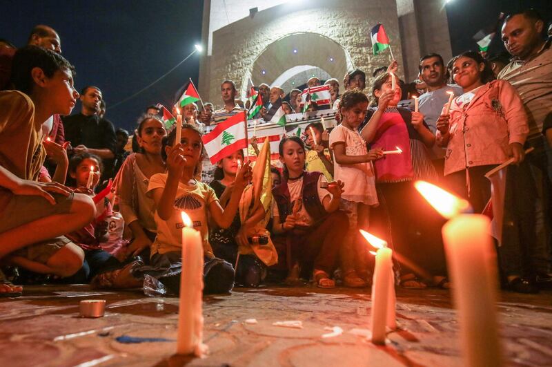 Palestinians attend a candlelight vigil in Rafah in the southern Gaza Strip, in support of Lebanon a day after a blast in a warehouse in the port of the Lebanese capital sowed devastation across entire city neighbourhoods. AFP