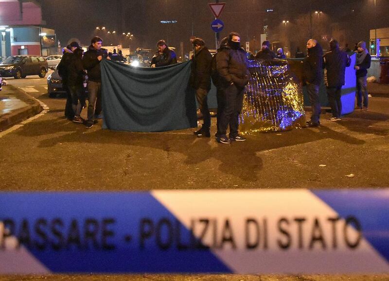 Italian Police officers work next to the body of Anis Amri, the suspect in the Berlin Christmas market lorry attack, in a suburb of the northern Italian city of Milan, Italy on December 23, 2016.  Reuters 