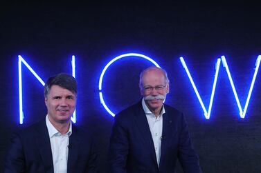 BMW chief executive Harald Krueger, left, with Daimler chief executive Dieter Zetsche. The firms aim to take on the likes of Uber and Lyft. Bloomberg