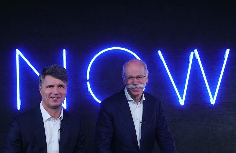 Harald Krueger, chief executive officer of Bayerische Motoren Werke AG (BMW), left, and Dieter Zetsche, chief executive officer of Daimler AG, react during a Bloomberg Television interview following a news conference in Berlin, Germany, on Friday, Feb. 22, 2019. Daimler and BMW are pouring more than 1 billion euros ($1.13 billion) into their joint car-sharing and ride-hailing businesses to take on the likes of Uber Technologies Inc. and Lyft Inc. Photographer: Krisztian Bocsi/Bloomberg