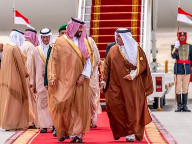 Bahrain's Crown Prince and Prime Minister Salman bin Hamad al-Khalifa, right, receiving Saudi Arabia's Crown Prince Mohammed bin Salman, centre left, in Manama on Thursday ahead of the 33rd Arab League Summit. Bahrain News Agency via AFP