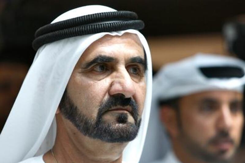 Sheik Mohammed bin Rashid al-Maktoum Prime Minister of UAE and ruler of Dubai, center, listens to an Emirati employee as he visits Al Maktoum International Airport, in Dubai, United Arab Emirates, Thursday July 1, 2010. In the desert beyond the skeletons of villas unfinished because of Dubai's economic slump, the home of the tallest building opened what could become another record-setter: an airport aiming to become the world's busiest. Civic boosters envision Dubai World Central-Al Maktoum International Airport, opened on Sunday, June 27, 2010, as one day growing into a mammoth transit hub of five parallel runways that could trump Atlanta's airport for the No. 1 spot. (AP Photo/Kamran Jebreili)