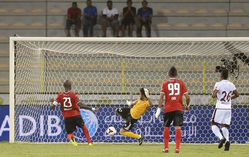 Al Ahli's Grafite watches as he slips the ball past Al Wahda goal keeper Adel Alhosani for one of his two goals on the night to lead Ahli. Sarah Dea / The National