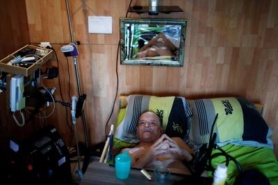 Alain Cocq, 57, in his medical bed he has been confined to for years as a result of a degenerative disease that has no treatment, poses after an interview with Reuters at his home in Dijon, France, August 19, 2020. Picture taken on August 19, 2020. REUTERS/Gonzalo Fuentes     TPX IMAGES OF THE DAY