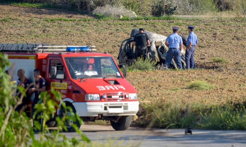 In this photo taken on October 16, 2017, police inspect the wreckage of investigative journalist Daphne Caruana Galizia's car after she was killed in a bomb blast close to her home in Bidnija, Malta.