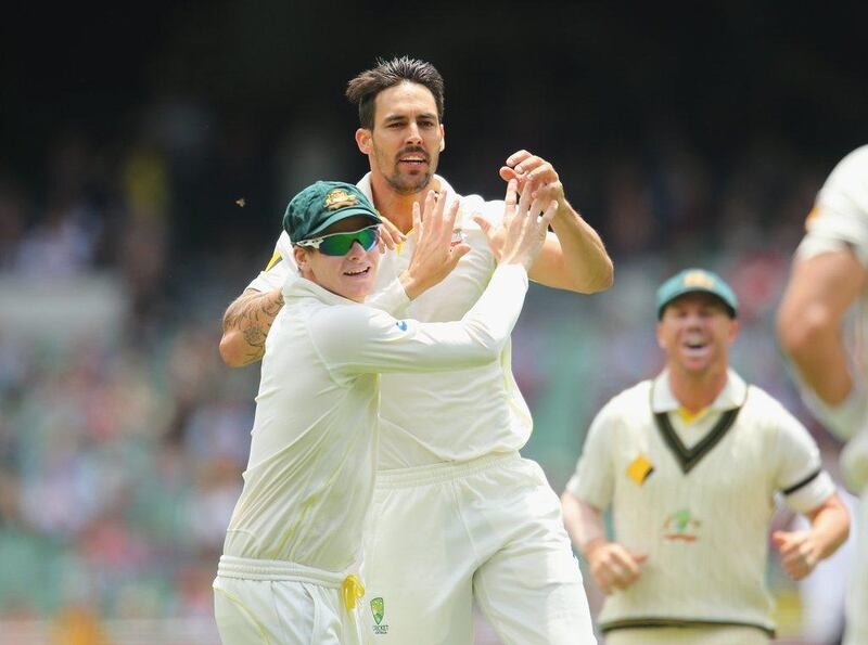 Mitchell Johnson of Australia is congratulated by Steven Smith after dismissing Lokesh Rahul of India during the final day of the third Test at Mebourne Cricket Ground on Tuesday. Scott Barbour / Getty Images / December 30, 2014 