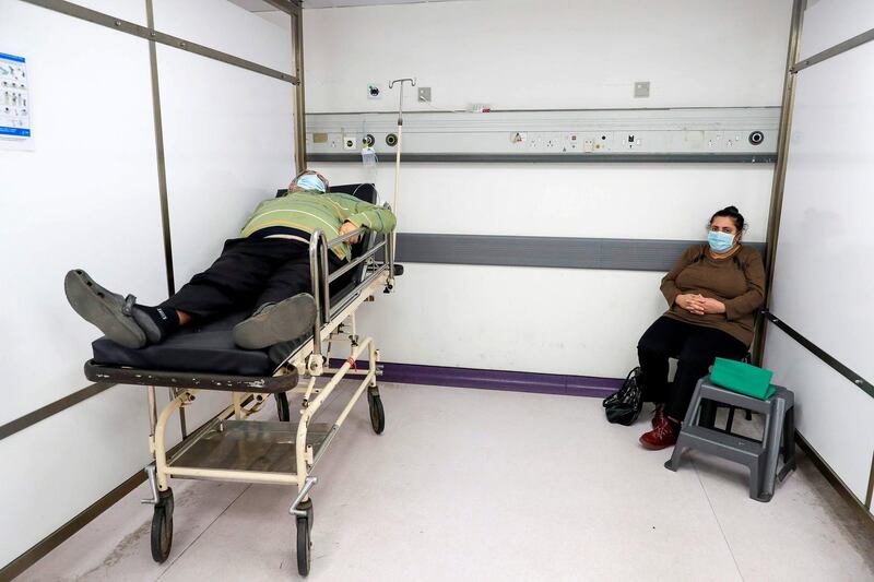 A man waits for treatment in the intensive care unit of the Rafic Hariri University Hospital in the Lebanese capital Beirut, on January 5, 2021. With 192,000 reported cases and almost 1,500 deaths, Lebanon is not among the world's worst hit countries, but its infrastructure is crumbling and a small surge in infections is enough to take its health sector to breaking point. / AFP / JOSEPH EID

