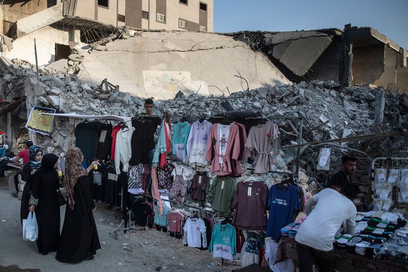 Women in Gaza City shop for clothes at a stall set up next to the rubble of destroyed buildings destroyed by Israeli air strikes during an 11-day war between Gaza's Hamas rulers and Israel. AP Photo