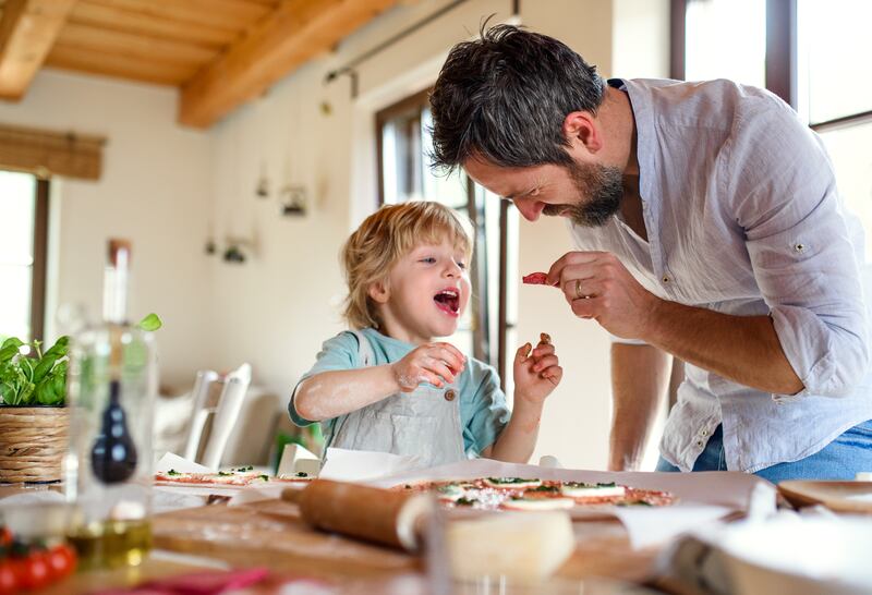 From preparing meals to playing singalong, fathers who co-parent take equal responsibility in raising their children. Photo: Getty