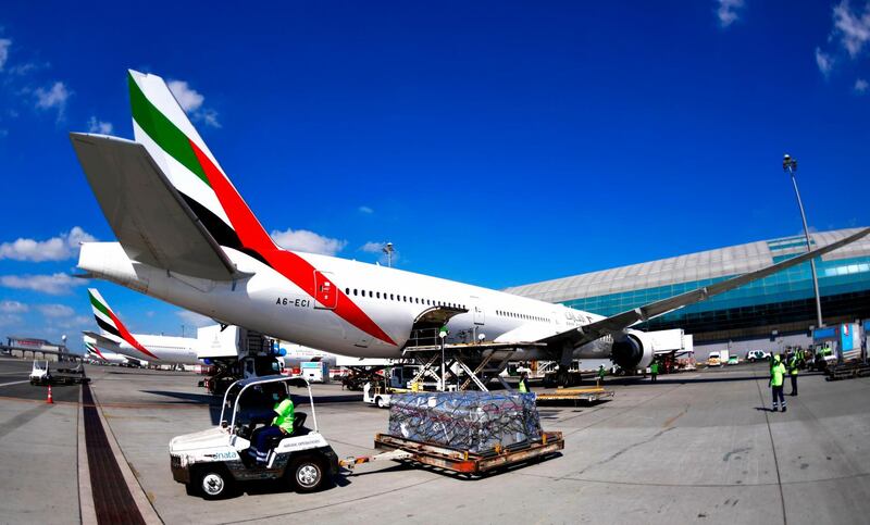 An Emirates Airlines Boing 777 plane unload a coronavirus vaccine shipment at Dubai International Airport on February 1, 2021 as key transport hub Dubai announced an initiative to accelerate the delivery of coronavirus vaccines, particularly to developing nations. The Vaccine Logistics Alliance, which includes Dubai-based Emirates airline and global logistics giant DP World, is designed to "speed up distribution of Covid-19 vaccines around the world through the emirate". The alliance will "support" the World Health Organization's Covax initiative to distribute two billion vaccine doses, the Dubai Media Office said in a statement, without specifying how many doses it would deliver.
 / AFP / Karim SAHIB

