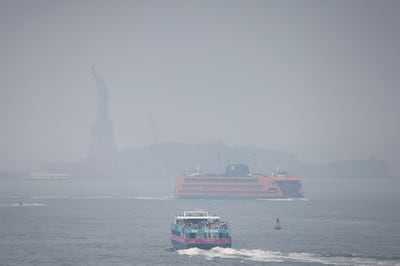 Ferry boats navigate New York Harbour through the haze and smoke from wildfires in Canada. New York Mayor Eric Adams told residents to take precautions. Reuters