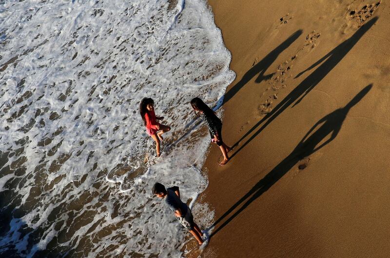 Children enjoy the beach in the city of Vina del Mar, Chile.  Reuters