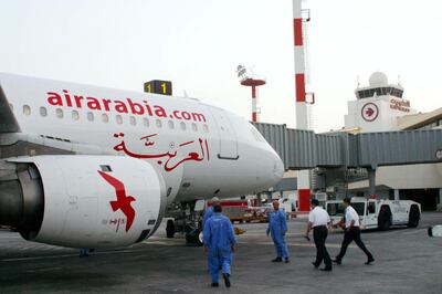 Ground crew attend to an Air Arabia Airbus A320 at Kuwait International Airport in October 2003. AFP