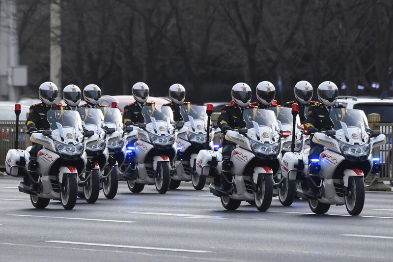 Police motorcycle escorts lead the motorcade Kim Jong-un in Beijing. AFP