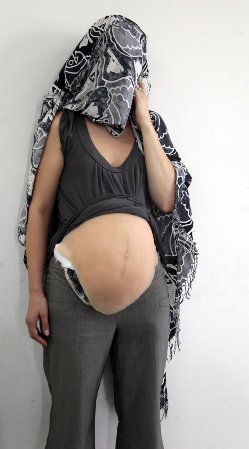 Handout picture released by Colombia's Police on September 11, 2013 showing Canadian national citizen Ritchie Tabatha Leah, after being detained at Bogota airport. A Canadian woman who pretended to be pregnant was captured while attempting to board a flight to her country, carrying 2kg of cocaine hidden under a latex belly, Colombian police said. AFP PHOTO/Colombian Police (Photo by HO / COLOMBIAN POLICE / AFP)
