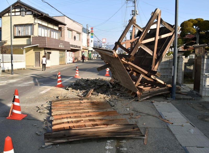 A damaged entrance of a house in Kori town, north of Fukushima city, northeastern Japan, following an earthquake Saturday. Residents in northeastern Japan on Sunday are cleaning up clutter in stores and homes after the strong earthquake set off a landslide on a highway, stopped trains and caused power blackouts for thousands of people. AP
