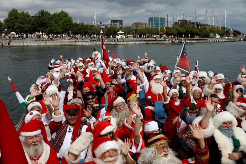 People dressed as Santa Claus wave from a barge during the World Santa Claus Congress in Copenhagen, Denmark. Andrew Kelly/Reuters