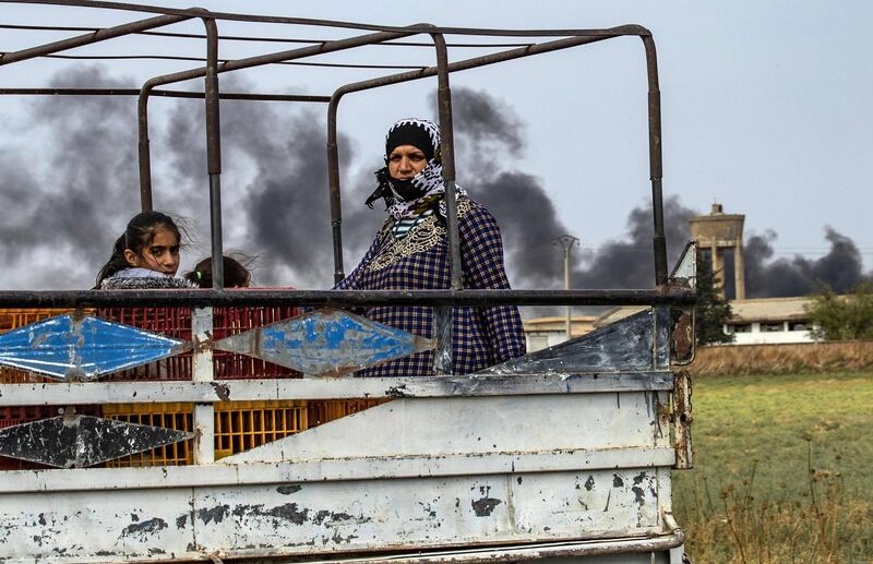 Syrians flee with their belongings.  AFP