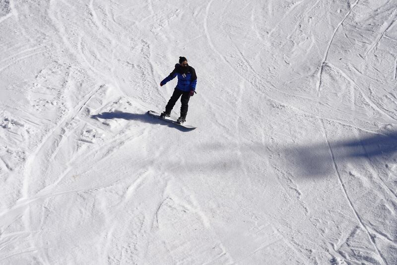 A snowboarder glides down the slopes at Kfardebian.