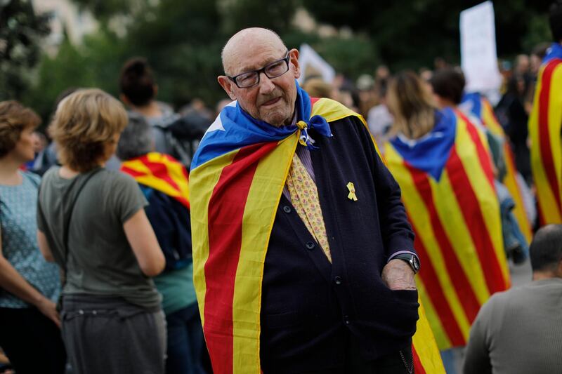 An elderly man joins a pro-independence gathering outside the Sagrada Família basilica i on the fifth day of protests over the conviction of a dozen Catalan independence leaders in Barcelona, Spain, Friday, Oct. 18, 2019. AP Photo/Bernat Armangue