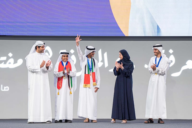 Ahmad Faisal Ali raises his hand in victory after being named the UAE winner of this year's Arab Reading Challenge. Among those pictured congratulating him is Sarah Al Amiri, Minister of State for Public Education and Advanced Technology. Photo: Sarah Al Amiri / X