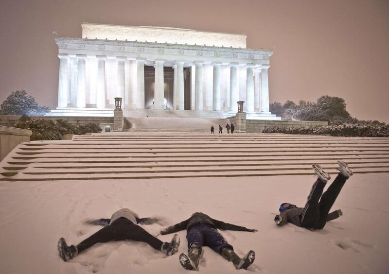 Young people make ‘snow angels’ in front of the Lincoln Memorial as a heavy snowstorm hits Washington, DC on February 13, 2014. The eastern US, in the grips of one of the most brutal winters in recent memory, braced for what forecasters warned could be the worst broadside yet — a massive storm with the season’s heaviest snowfall. Mladen Antonov / AFP photo