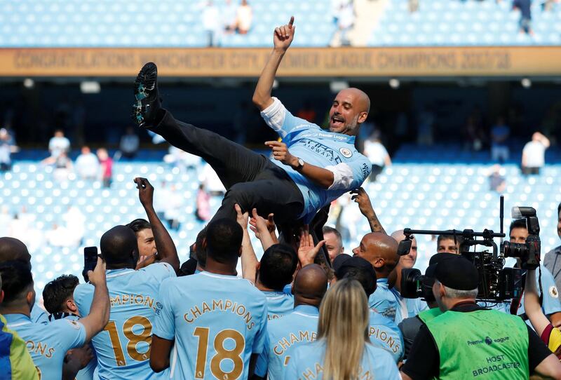 Manchester City manager Pep Guardiola is thrown into the air by his players as they celebrate after winning the Premier League title. Carl Recine/ Action Images via Reuters