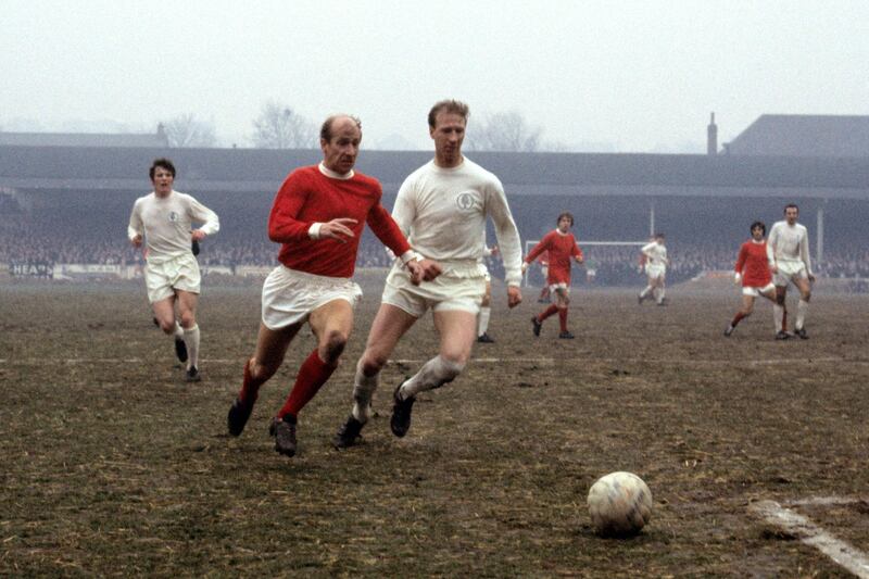 Manchester United's Bobby Charlton (left) takes on Leeds United's Jack Charlton. PA