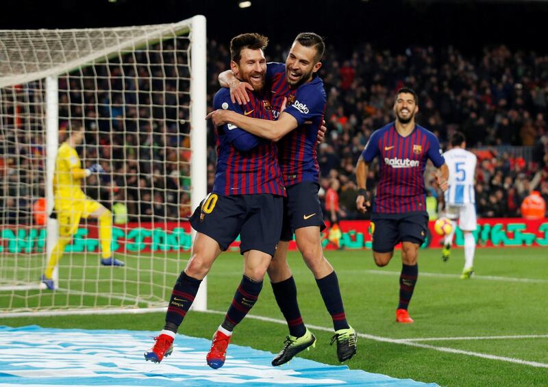 Lionel Messi celebrates scoring Barcelona's third goal with Jordi Alba. Reuters