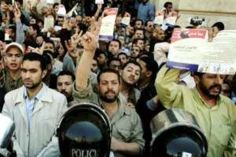Hundreds of members from Egypt's main opposition group _ the Muslim Brotherhood _  demonstrate in Alexandria, Egypt, Tuesday, April 1, 2008,  protesting the government's wave of arrests targeting the group's leaders and potential candidates in upcoming local elections. Arabic slogan read as " No for security control to the local elections" (AP Photo)      