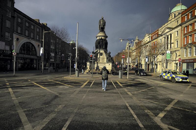 A Garda (Irish police) car is seen patrolling an empty O'Connell Street during the government's lockdown restrictions, amid the spread of the coronavirus disease (COVID-19) pandemic, in the city centre of Dublin, Ireland, January 23, 2021. REUTERS/Clodagh Kilcoyne