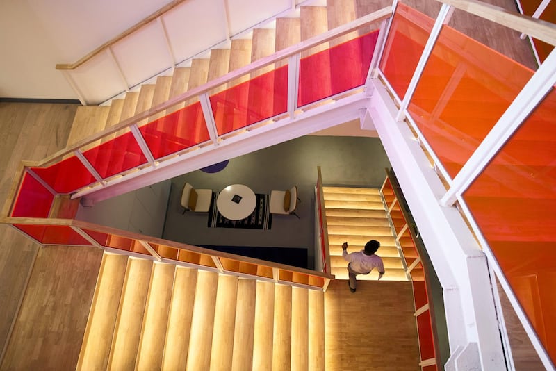 A member walks down a flight of stairs at the WeWork Cos. 32nd Milestone co-working space in Gurugram, India, on Monday, Feb. 18, 2019. The New York-based co-working giant WeWork Cos, which operates shared office spaces around the world, has attracted huge piles of investor money, which it uses to snap up office space in the largest cities on earth. Photographer: Ruhani Kaur/Bloomberg