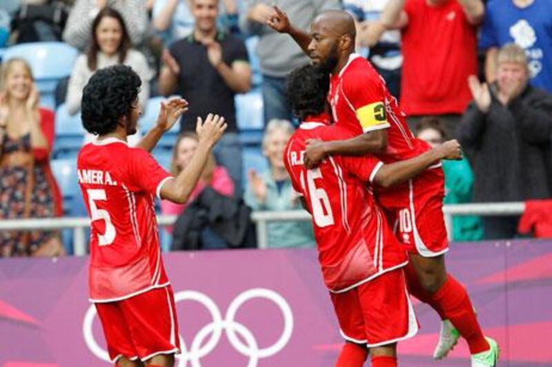 Ismaeil Matar celebrates his goal against Senegal with Amer Abdulraham and Rashed Eisa