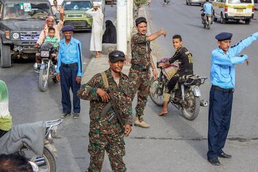 Yemeni policemen (in blue) and Houthi fighters control the traffic at the centre of the port city of Hodeidah, around 230 kilometres west of the capital Sanaa, on May 13, 2019. AFP