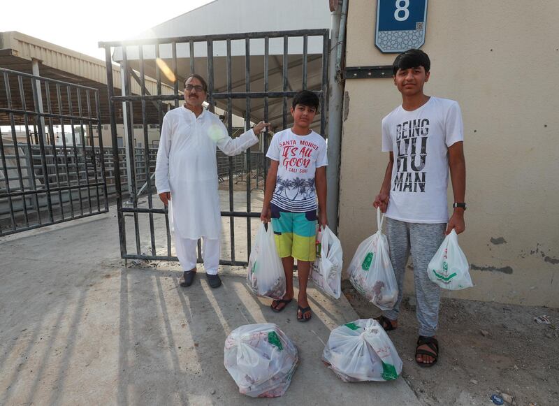 Abu Dhabi, U.A.E., August 22 , 2018.  Livestock shoppers for the second day of Eid Al Adha at the Abu Dhabi Livestock Market and the Abu Dhabi Public Slaughter House (Abu Dhabi Municipality) at the  Mina area. --  (R-L)  Palistani brothers, Ahmed-14 and Mohammad Haris-13 with goat and lamb meat which they just had butchered at the Abu Dhabi Municipality Public Slaughter House.
Victor Besa/The National
Section:  NA
For:  stand alone and stock images