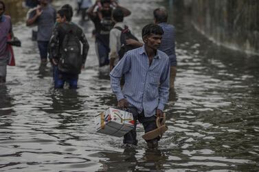 Pedestrians wade through flood water in Mumbai, India, on Tuesday, July 2, 2019. Bloomberg