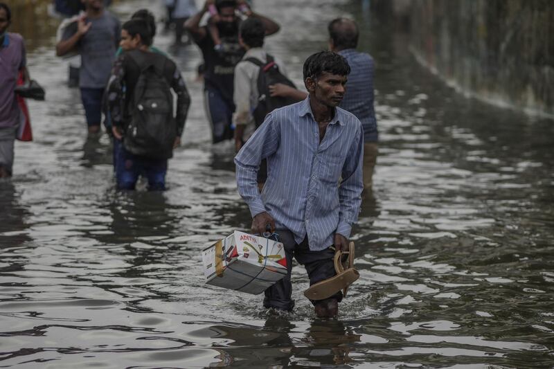 Pedestrians wade through flood water in Mumbai, India, on Tuesday, July 2, 2019. The heaviest downpour since 2005 inundated Mumbai, delaying trains and planes and spurring the city administration to declare a holiday. Photographer: Dhiraj Singh/Bloomberg