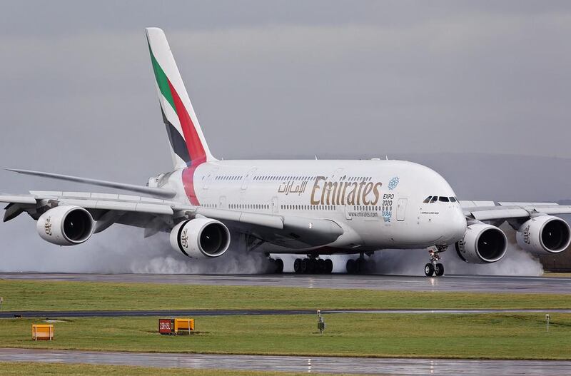 The Emirates jet lands safely, but standing water on the runway sprays under braking. Photo by Picturematt / REX 